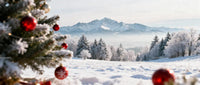 Snowy landscape with decorated Christmas tree and mountains