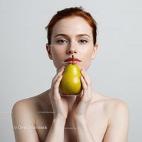 Elegant Woman Holding Yellow Pear in Minimalist Portrait