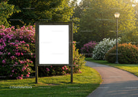 Empty wooden billboard surrounded by summer garden path
