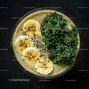 Healthy Green Smoothie Bowl with Banana Slices and Kale