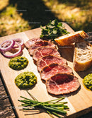 Sliced roast beef with herbs and rustic bread