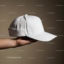 Hand Holding Classic White Baseball Cap On Neutral Background