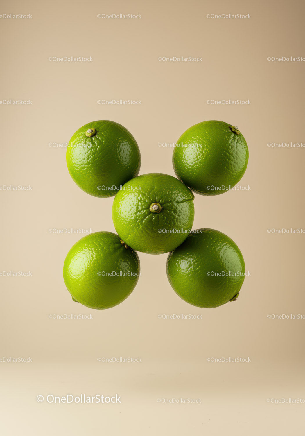 Fresh green limes arranged on a beige background