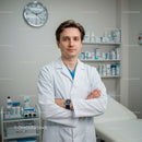 Professional Male Doctor Standing in Hospital Examination Room