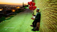 Man with Heart Balloons and Chocolates at Sunset