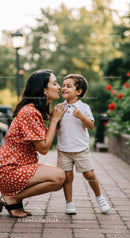 Mother sharing a tender moment with her smiling son outdoors