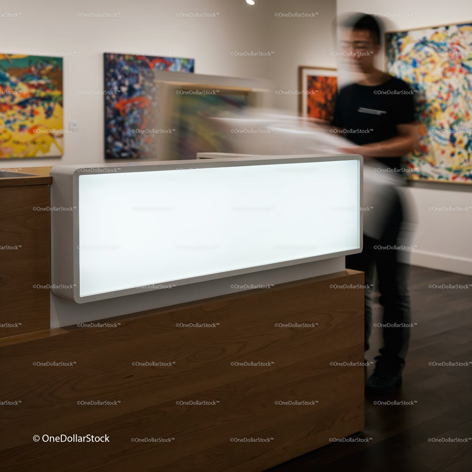 Gallery staff handling painting in contemporary art space