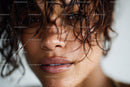 Close-up of a Woman with Wet Curly Hair and Expressive Eyes
