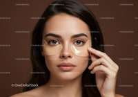 Young Woman Applying Under-Eye Patches for Skincare Treatment