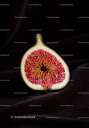 Close-up of ripe fig half on dark textured surface