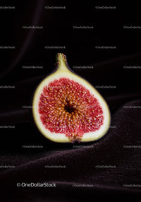 Close-up of ripe fig half on dark textured surface
