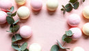 Delicate Pastel Macarons with Eucalyptus on Pink Background