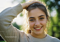 Young Woman Smiling Outdoors in Bright Sunlight