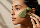Woman Using Jade Roller for Facial Skincare and Relaxation