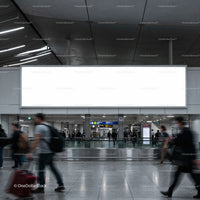 Busy airport terminal with blank advertising billboard