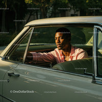 Young Man Driving Vintage Car in Scenic Outdoor Environment