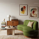 Modern living room with green curved sofa and abstract art