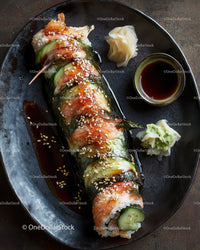 Delicious Salmon Sushi Roll with Fresh Vegetables and Sauce