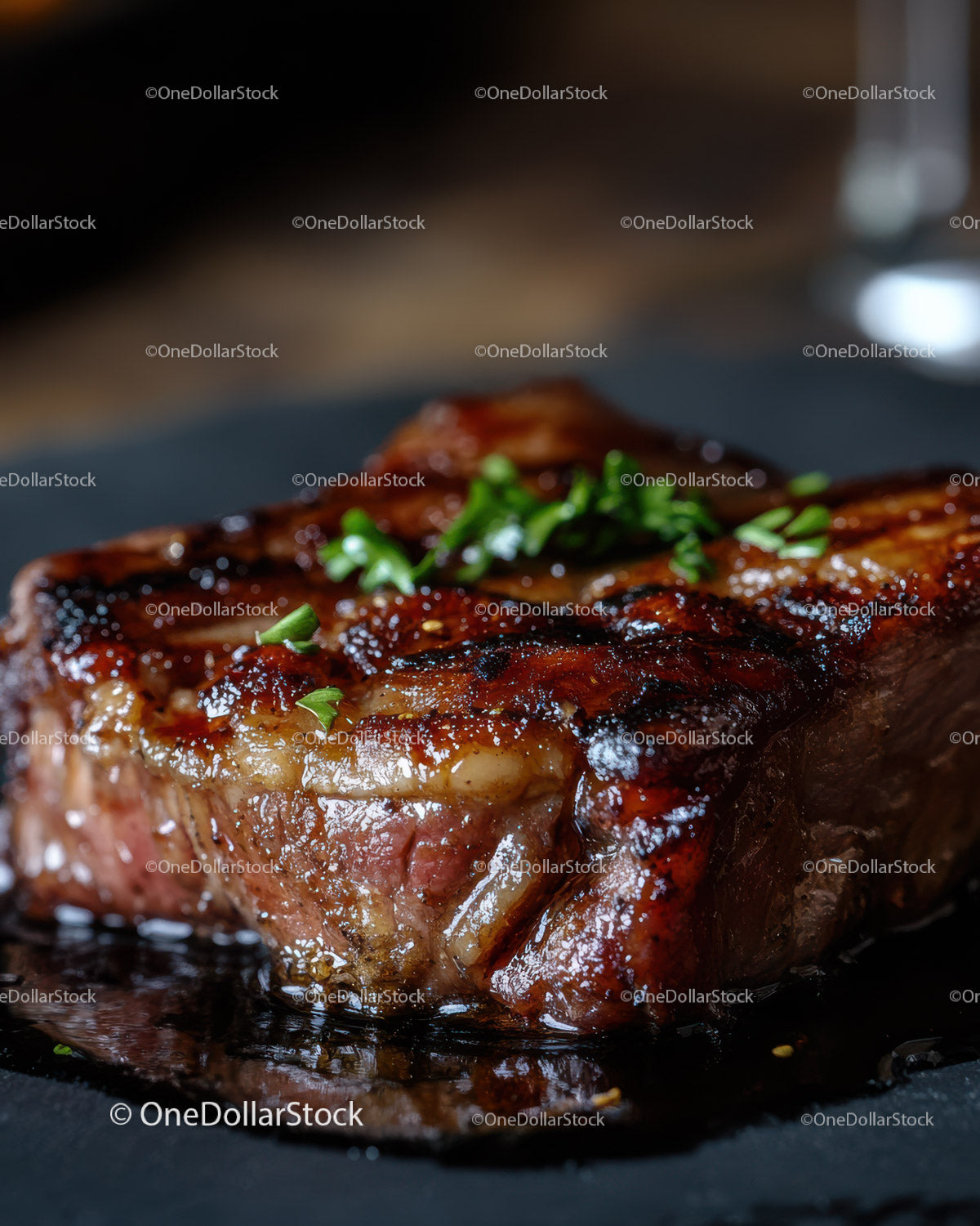 Delicious Juicy Grilled Steak with Herbs on Black Plate