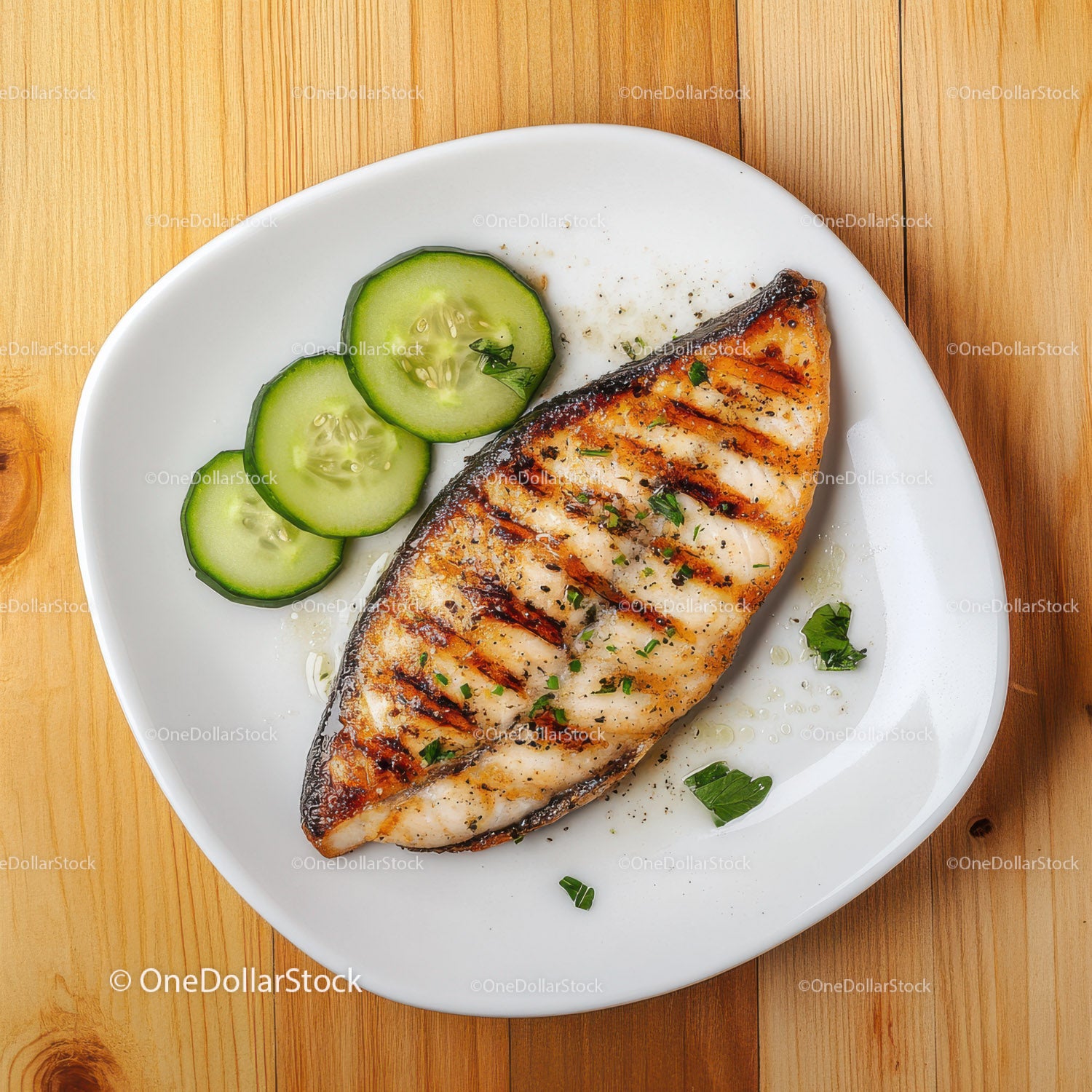 Grilled Salmon with Cucumber Slices on White Plate