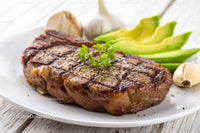 Juicy Grilled Steak with Fresh Avocado and Herb Garnish
