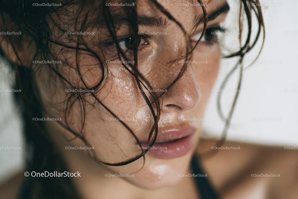 Close-up of Freckled Woman with Wet Hair and Moist Skin