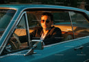 Stylish Man in Sunglasses Sitting in Classic Vintage Car at Sunset