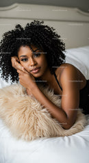 Young woman relaxing on cozy bed with fluffy pillow