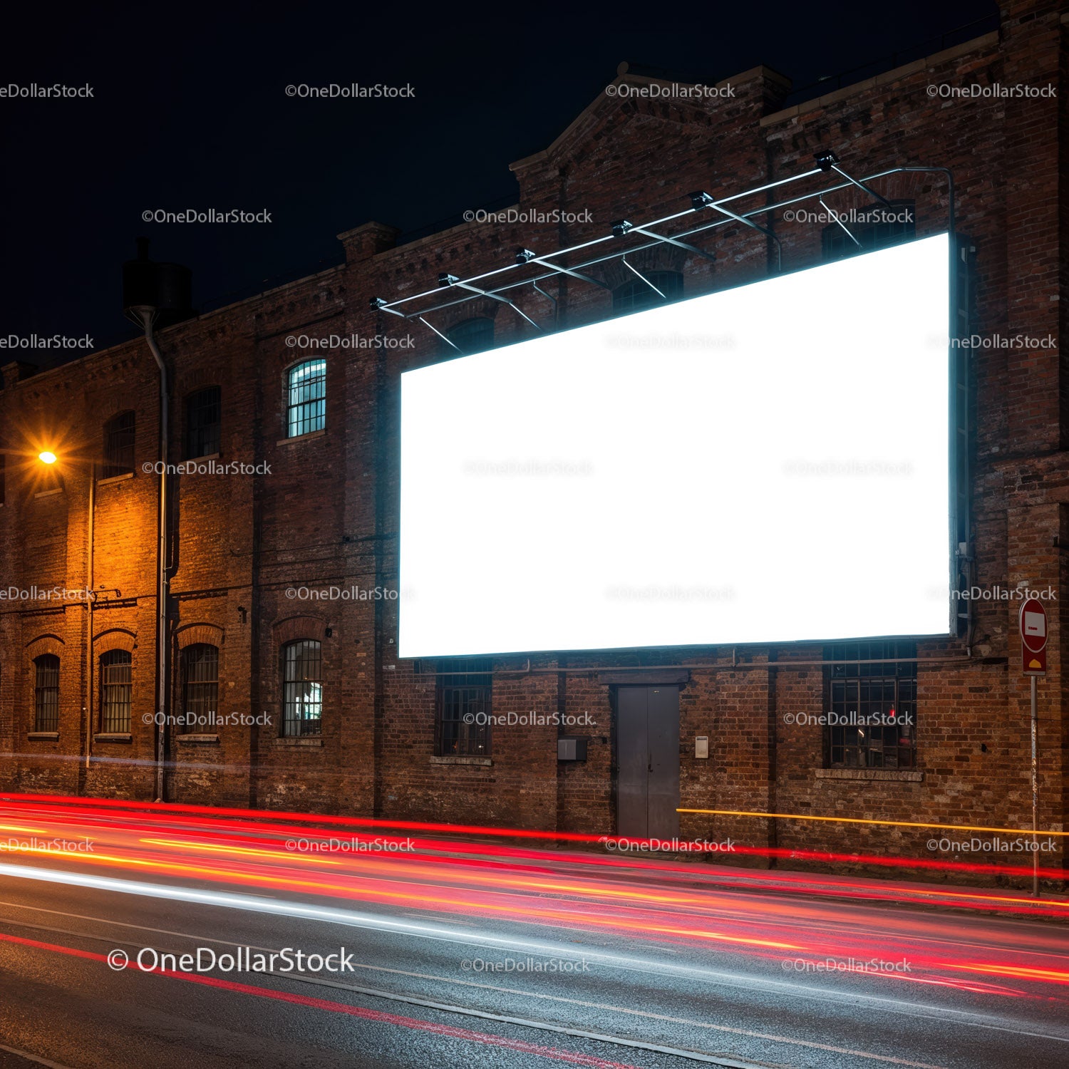 Podświetlony pusty billboard na ceglanym budynku w nocy