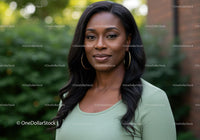 Confident woman with long hair outdoors in soft light