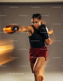 Focused female boxer throwing a powerful punch in motion