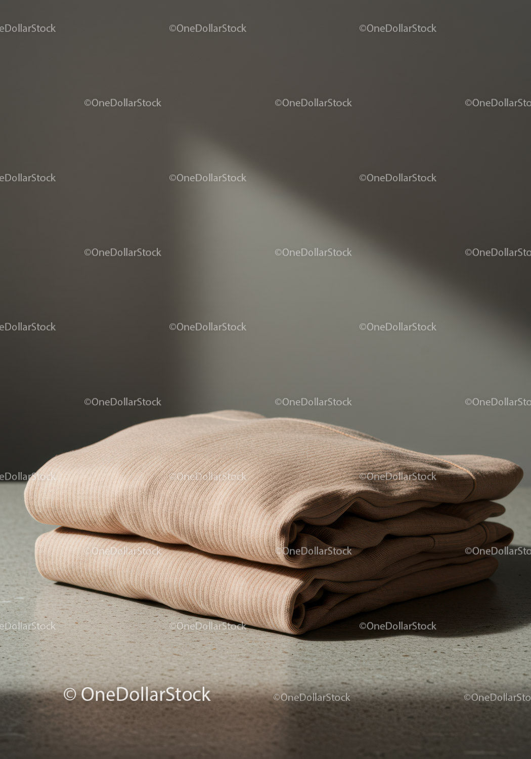 Beige Ribbed Sweater Folded on a Neutral Surface