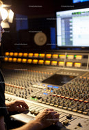 Audio Engineer Adjusting Sound Levels in Recording Studio