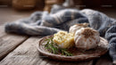 Roasted Garlic Cloves with Rosemary on Rustic Wooden Table