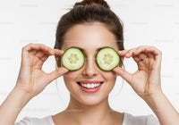 Smiling Woman Holding Cucumbers Showing Fresh Skin and Happiness