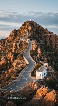 Scenic Mountain Road Leading to White Lighthouse and Rocky Hills