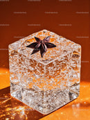 Close up of crystal clear ice cube with star anise