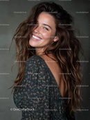 Smiling Woman with Wavy Hair Wearing Metallic Dress in Studio