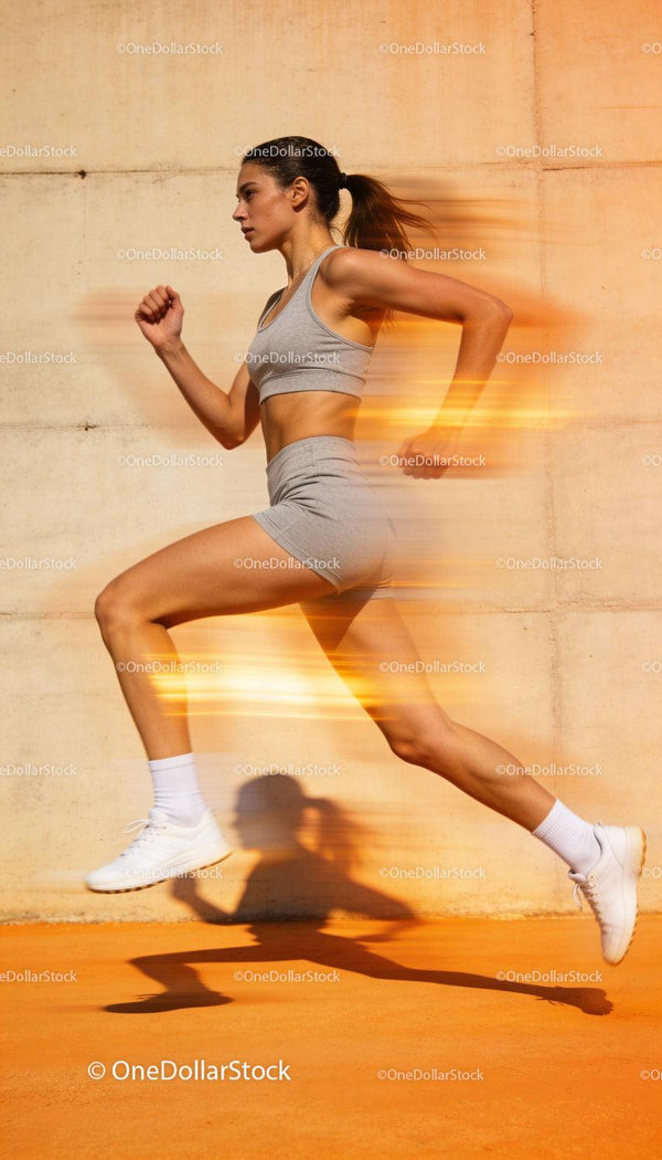 Focused woman sprinting outdoors with dynamic motion blur