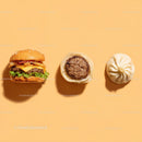 Gourmet Burger with Lettuce and Tomato Next to Grilled Steak and Dumpling