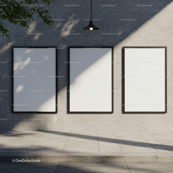 Three blank posters on urban textured wall under lamp JPG Mockup Image