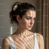 Elegant Woman with Blue Eyes and Floral Hair Accessory Indoor Portrait