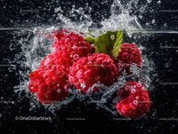 Fresh Red Raspberries Falling into Water Splashing Effect