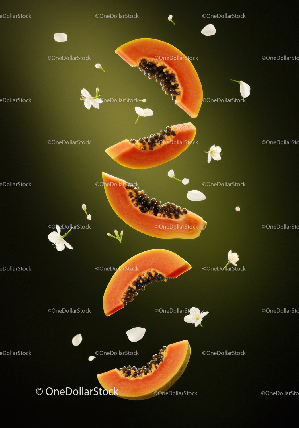 Slices of ripe papaya with delicate white flowers falling