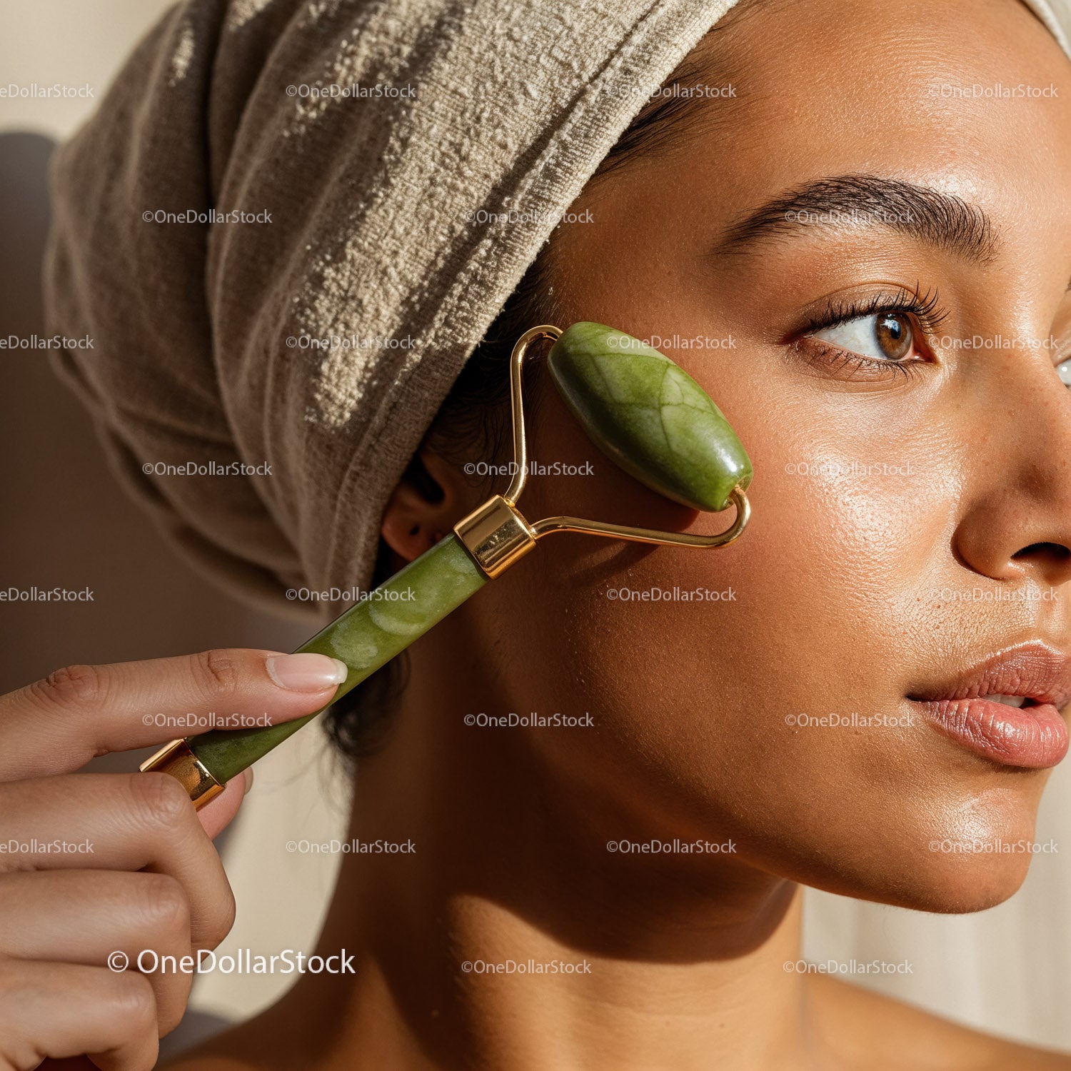 Close-up of a womanusing jade roller for facial massage skincare