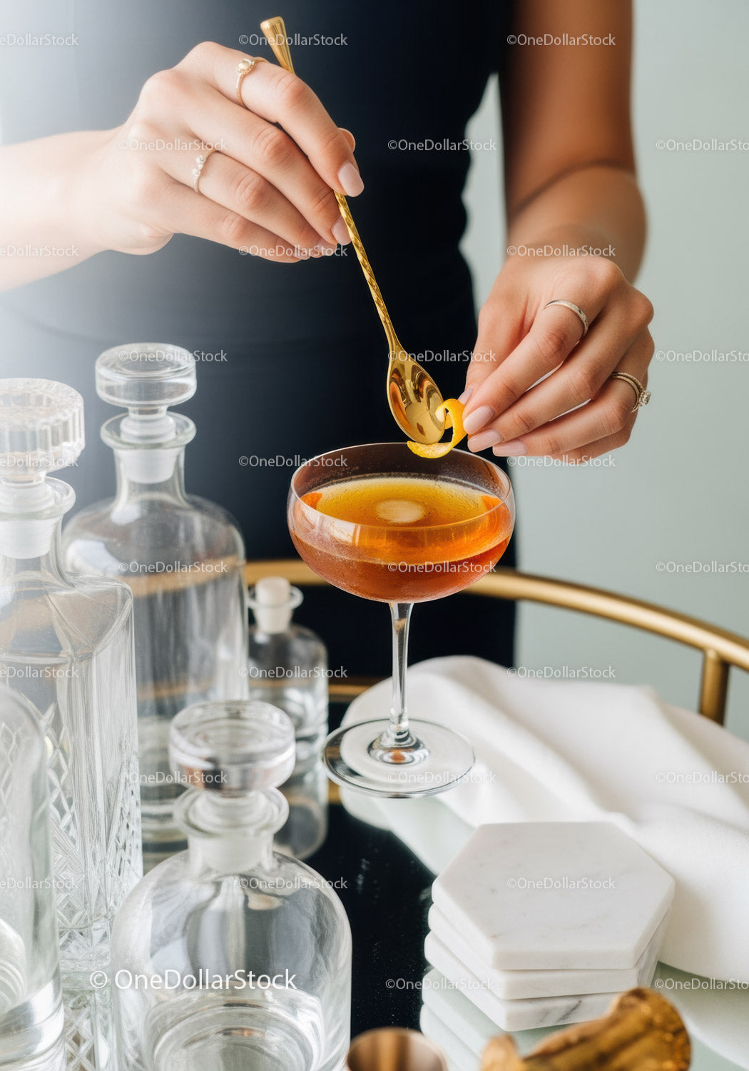 Elegant Orange Cocktail in Stylish Martini Glass with Gold Bar Spoon
