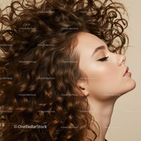Profile of woman with voluminous curly hair on beige background
