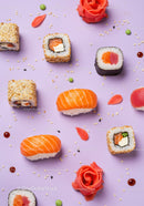 Assorted fresh sushi pieces with ginger on lilac background