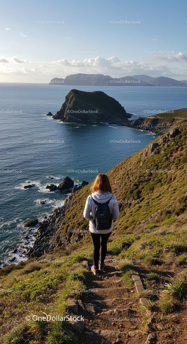 Hiker Walking along Rugged Coastline with Scenic Ocean View