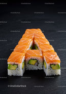 Fresh salmon sushi rolls with avocado on black slate